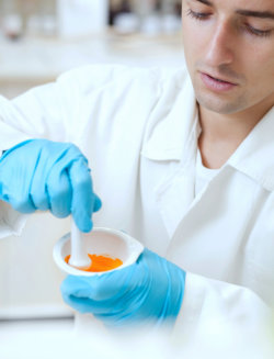 chemist holding a mortar and pestle
